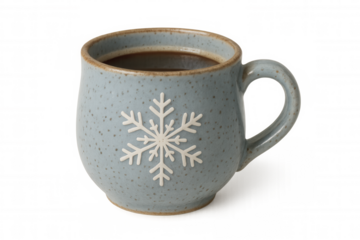 Steaming hot coffee filling ceramic blue mug with snowflake pattern, creating winter warmth against crisp white backdrop