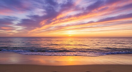 Breathtaking ocean sunset with a sky ablaze in vibrant hues of purple, orange, and pink, casting a golden glow over the tranquil waves and sandy beach