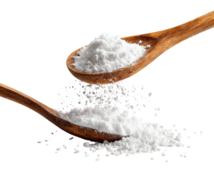 Two wooden spoons overflowing with white powder, some scattering