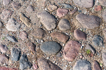 background of stones arranged in the ground. close-up of the stone structure,