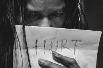 Hurt Written on Paper Held in Hand – Expression of Sadness and Depression