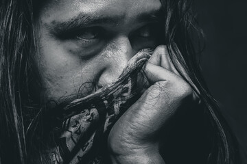 Person Covering Face with Clothing in Dramatic Light – Depression Concept