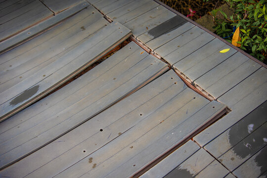 wood plastic composite decking WPC on swimming pool side, material degradation wear and tear. decking problems concept.