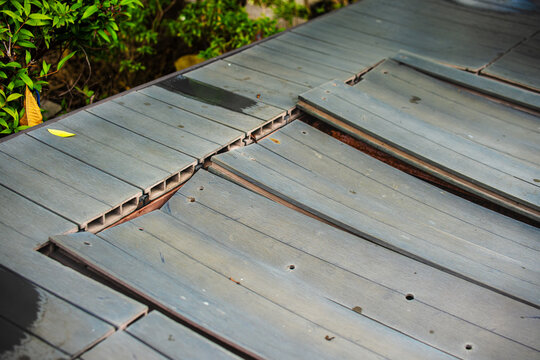 wood plastic composite decking WPC on swimming pool side, material degradation wear and tear. decking problems concept