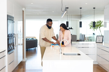Couple preparing meal together in modern kitchen, enjoying quality time at home