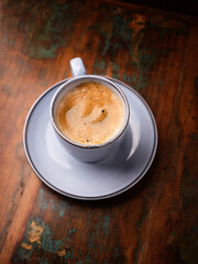 Cup of coffee on rustic wooden background. Soft focus. Copy space	
