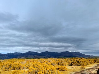 Scenic View of New Zealand Landscape Under a Dramatic Cloudy Sky