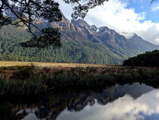 Serene wilderness landscape with mountain reflections in Fiordland National Park, New Zealand