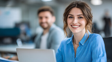 Happy Woman Accountant at Work in Office Environment with Laptop and Colleagues in Background