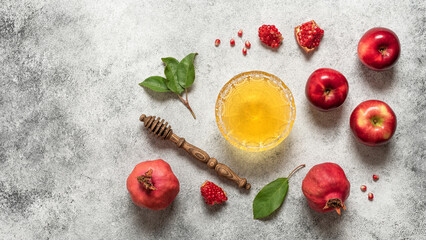 Honey, apples and pomegranate on a light grunge background. Jewish New Year. Rosh Hashanah. Top view, flat lay, banner.