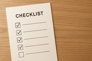 Checklist to do list and task list concept with blank paper on wooden desk ready for writing goals or reminders, creating sense of organization and productivity