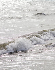 Close up shot of sea surf with splashing foam