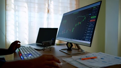 Person analyzing stock market data on a computer at home office - Powered by Adobe
