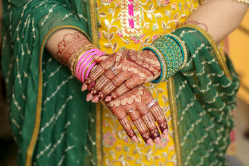 Intricate Henna Hand Art with Colorful Bangles and Embellished Attire