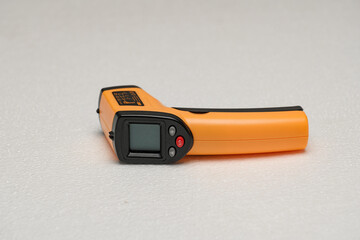 Handheld infrared thermometer in orange