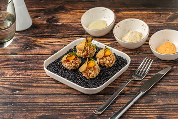 Gourmet quinoa balls with crispy texture and artistic garnish