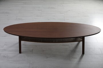 Empty wooden table on floor indoors. Stylish furniture