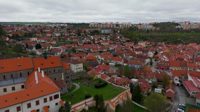 Cinematic drone shot flying past the historic 12th Century St. Procopius Basilica, overlooking the UNESCO Jewish Quarter of Trebic, Vysocina, Czech Republic.