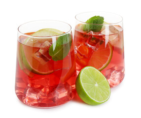 Tasty punch with ice, mint and slices of lime in glasses isolated on white. Refreshing drink