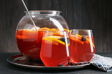 Fruity punch on black table, closeup. Refreshing drink