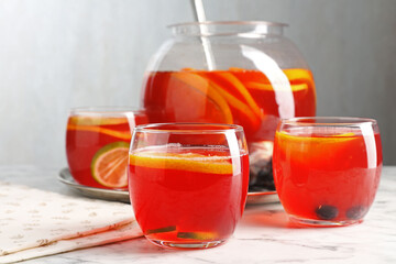 Fruity punch on white marble table, closeup. Refreshing drink