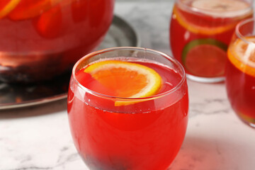 Fruity punch on white marble table, closeup. Refreshing drink