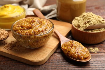 Different types of mustard on wooden table, closeup