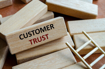 A wooden block showing CUSTOMER FOCUS on steps highlighting service, quality, reliability and organizational trust.