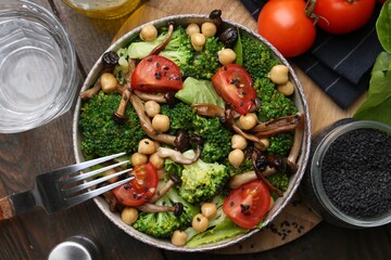 Delicious salad with shimeji mushrooms served on wooden table, flat lay