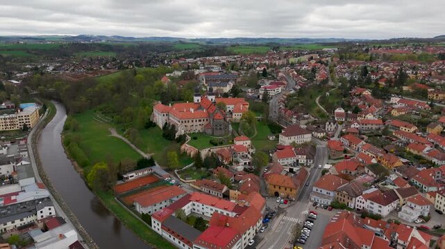 Cinematic aerial circling shot of the historic 12th Century St. Procopius Basilica, a UNESCO World Heritage site overlooking the Jewish Quarter in Trebic, Czech Republic.