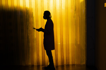silhouette man business owner using checklist recheck amount of stock product inventory on shelf at distribution warehouse factory.logistic business ship and delivery, inventory flow, professional.