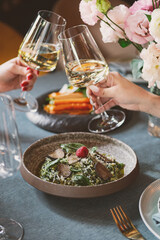 An Elegant Dining Experience Featuring Fine Cuisine and Toasting to