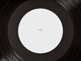Close-up of blank vinyl record showing grooves and white label