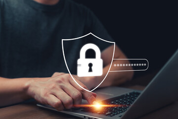 Close-up of hands typing on a laptop with digital shield and lock icon overlay, representing cybersecurity, password protection, online privacy, and data security in the digital world.