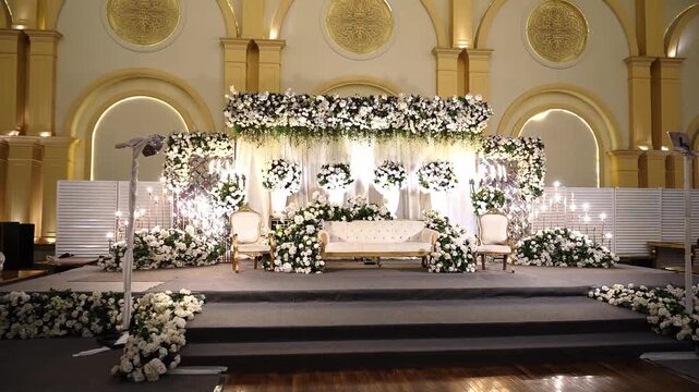 Elegant Wedding Stage with Golden Backdrop and White Floral Decoration