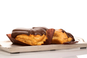 Chocolate sweet eclair, macro, isolated on white background.