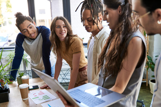 Collaborative team meeting among young coworkers in a vibrant office environment during work hours