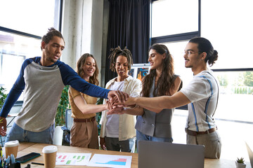 Team of young professionals collaborating in a modern office setting filled with energy