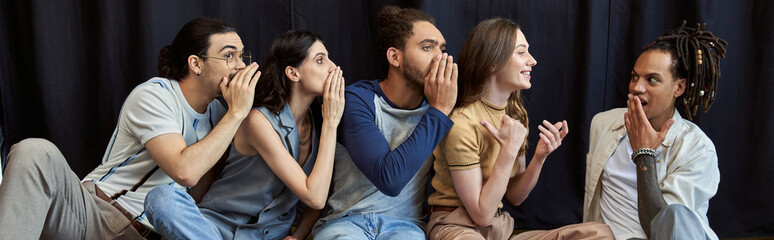 Stylish young friends sharing secrets and laughter in a cozy indoor setting