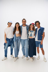 Obraz premium Stylish young friends celebrate their joy and fashion in a creative studio setting