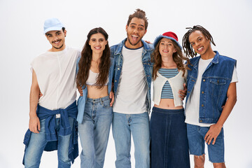 Fototapeta premium Stylish friends sharing laughter in a playful attire selection for fashion exploration