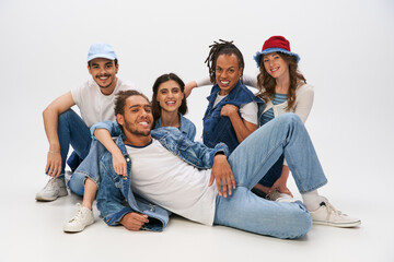 Young stylish friends enjoying a trendy group moment in casual fashion at a bright studio