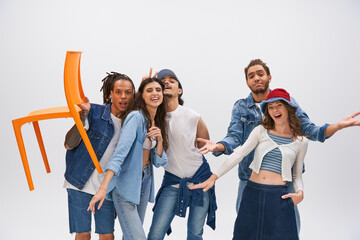 Fototapeta premium Young stylish friends celebrate friendship with fashion in a vibrant studio setting