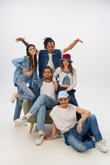 Fototapeta premium Young friends showcase trendy styles in a casual, lively indoor setting filled with joy