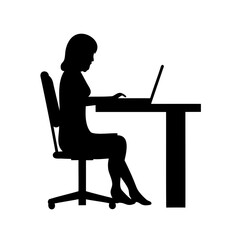 Silhouette of a woman working on a laptop at a desk