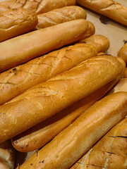 Fresh Golden French Baguettes in Bakery.
