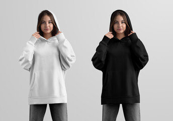 Mockup of white, black long hoodie with pocket on girl in gray jeans, casual oversized sweatshirt with hood, front view.