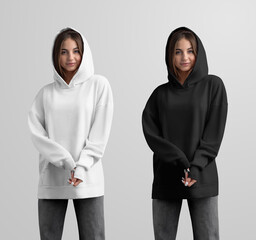 Mockup of white, black long hoodie with pocket on girl in hood, gray jeans, casual oversized sweatshirt, front view.