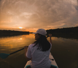 Paddleboarding at Sunset on a Calm Lake