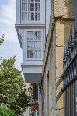 Traditional White Bay Window Architecture in Historic European Stone Building. Cantilever balcony, limestone facade, heritage, architectural details